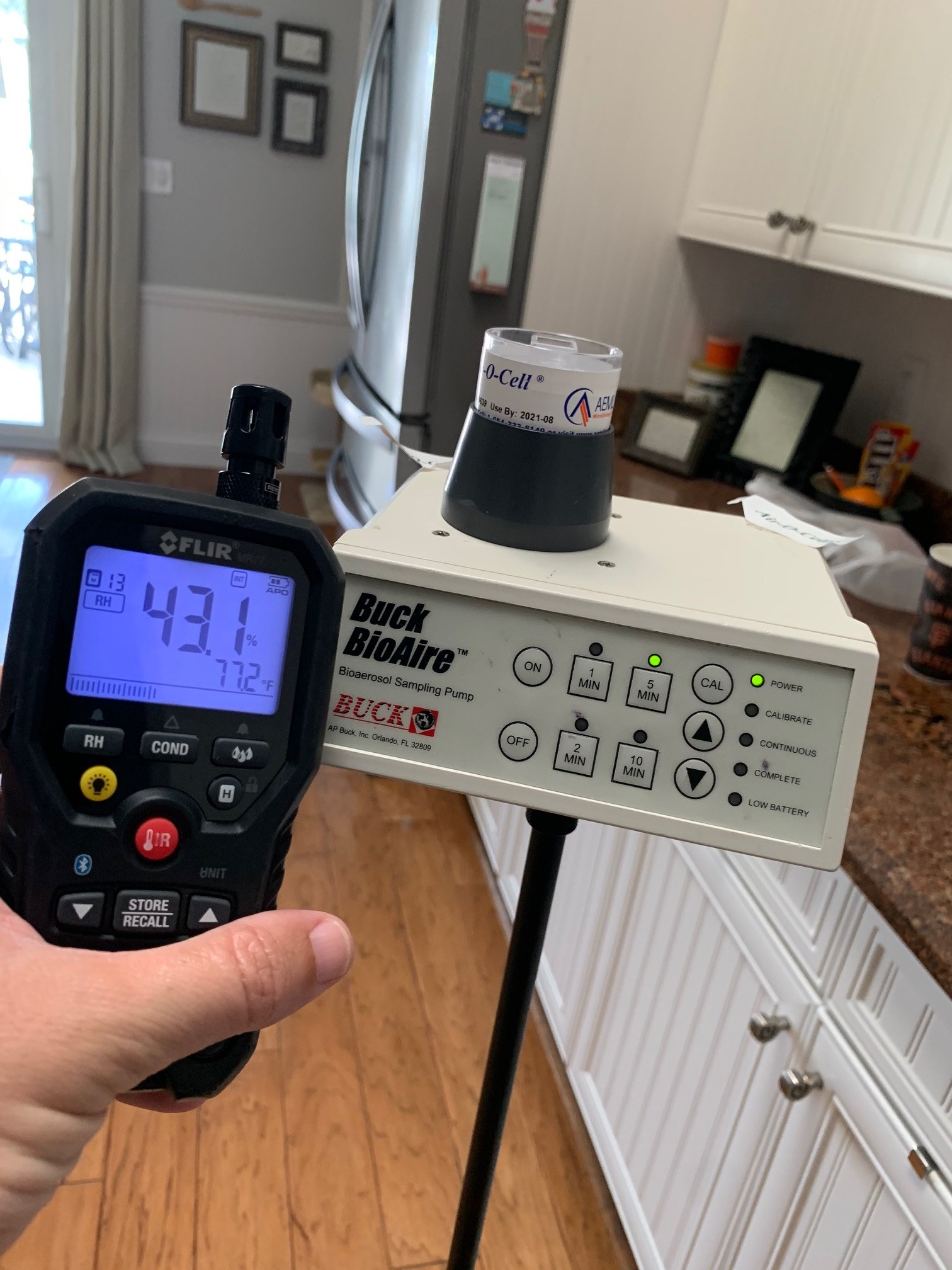 Professional air sampling pump and FLIR humidity meter used in mold testing South Florida